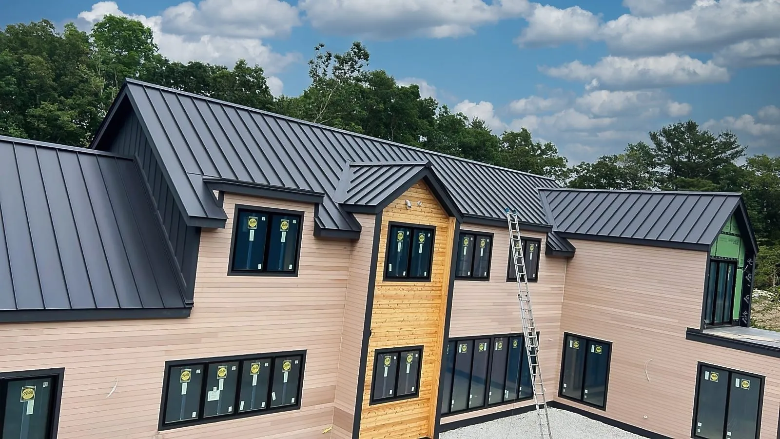 Standing seam roof on a two-story home with a pool