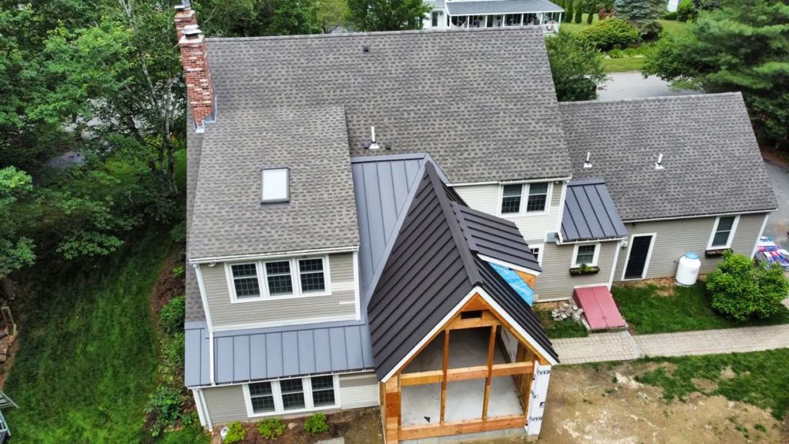 Shingle field, standing seam porch and entry