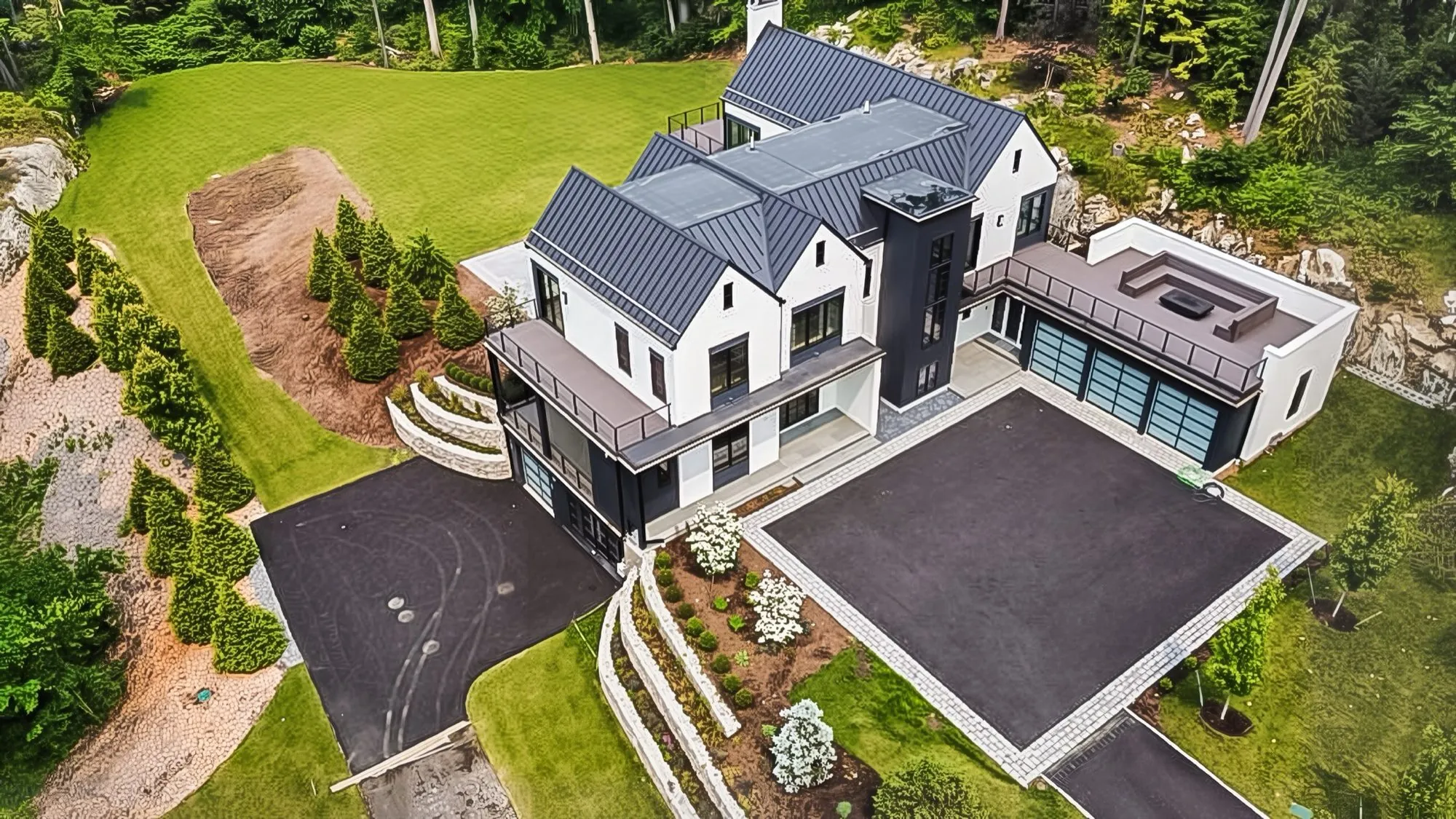 Modern farmhouse with a full standing seam roof, seen from above