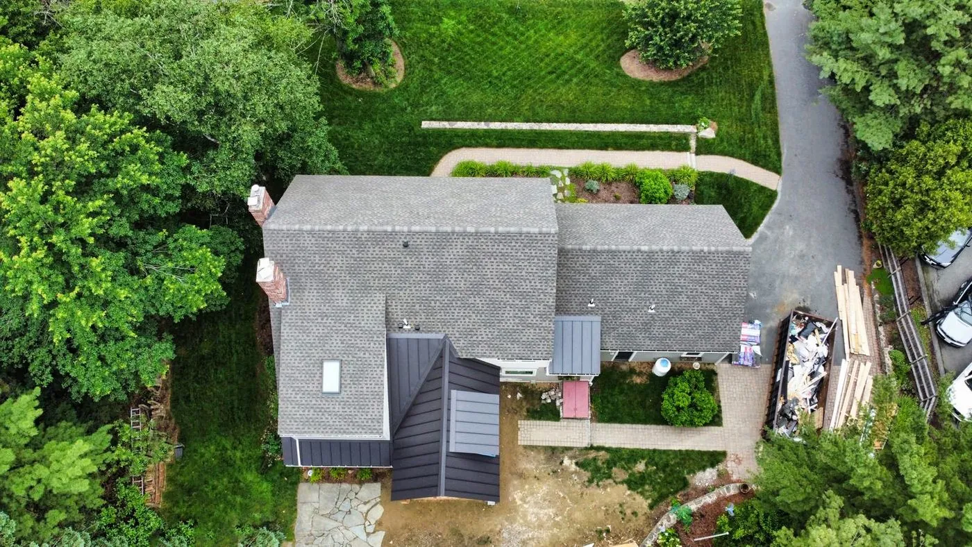 Metal accent roof on a shingle home, from above