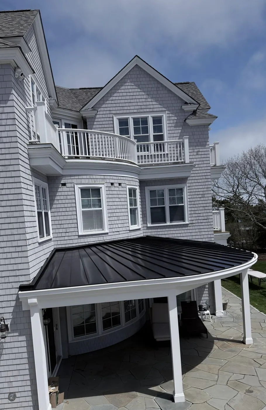 Curved porch roof in black standing seam