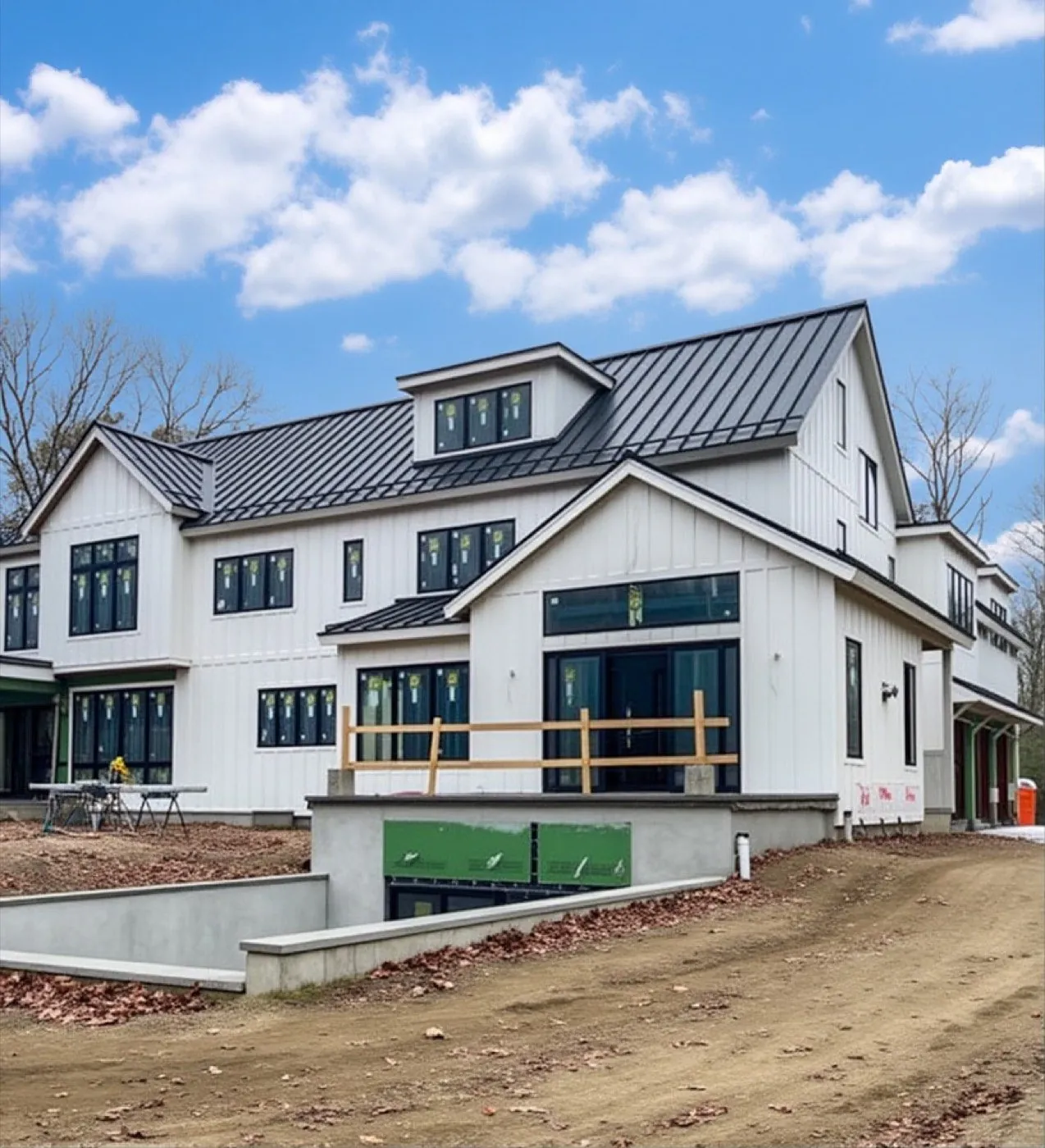White farmhouse, dark standing seam